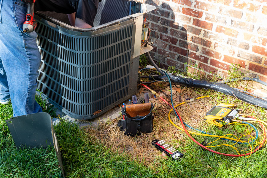 Air conditioning unit outside a home being prepped for repairs