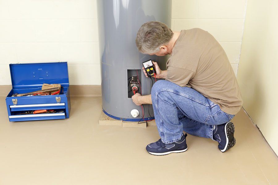 Technician performing a water heater repair